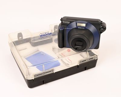 someone is taking a picture of a camera in a clear case