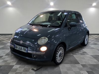 a picture of a small blue car parked in a garage