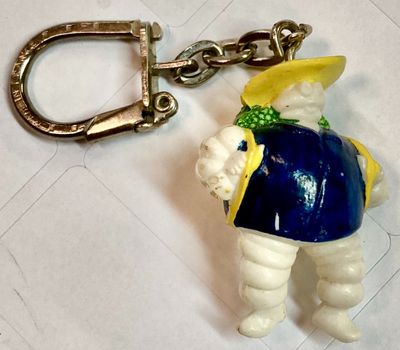 a keychain with a figurine of a man wearing a hat