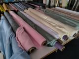 many rolls of fabric on a table in a room