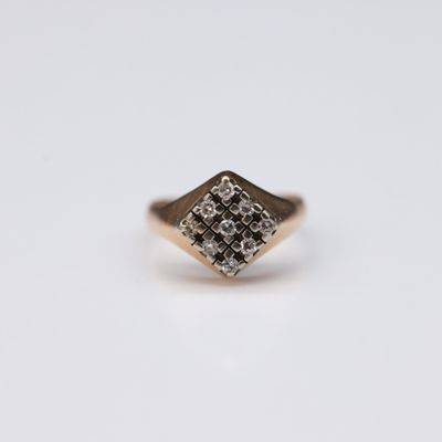 a close up of a gold ring with diamonds on it