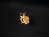 a gold elephant charm on a black background