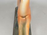a figurine of a horse on a green base