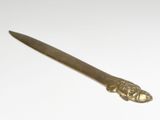 a knife that is sitting on a white surface
