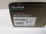 fuji finepix sx4000 camera with box on table