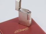 a silver lighter sitting on top of a red book