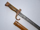 an image of a knife with a wooden handle on a white surface