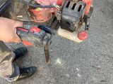 a man that is working on a machine on the ground
