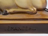 a statue of a cat sitting on top of a base