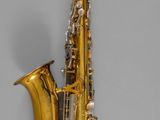 a gold saxophone with a black and white background