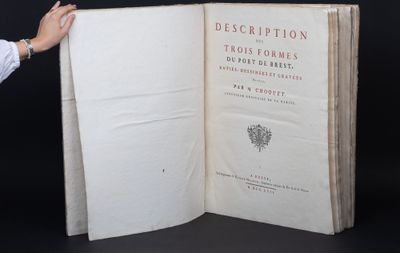 a person holding an open book in their hand