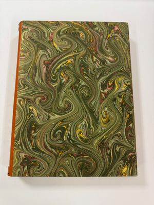 a close up of a book on a table with a white background