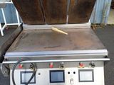 an image of a commercial fryer with two pans on it
