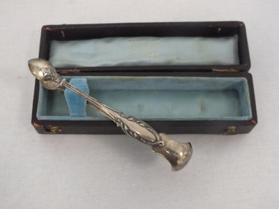 a silver spoon in a box on a table
