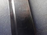 a close up of a knife with a crown on it