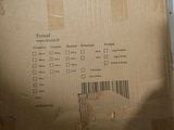 cardboard box sitting on top of a table with a barcode on it