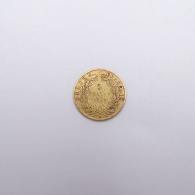 a close up of a gold coin on a white surface