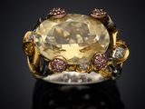 an image of a ring with a large yellow topazr surrounded by pink and white diamonds