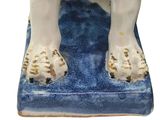 a figurine of a dog on a blue rug