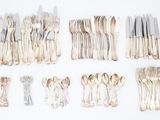 a lot of forks and spoons that are on the table
