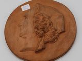 an image of a clay plaque of a woman and a dog