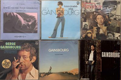 many different album covers on the wall of a room