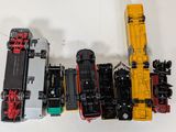 several toy trains are lined up next to each other on a white surface