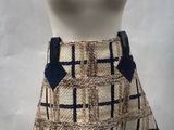 beige and black checkered skirt with blue bow accent