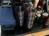 a black suitcase with a bunch of glasses and bottles on it