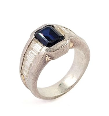 an image of a ring with a blue stone in it