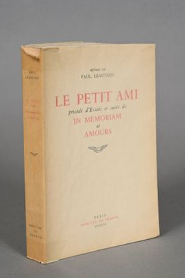 an old book sitting on top of a table on a gray surface