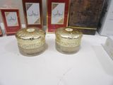 two gold containers are sitting next to each other on a table