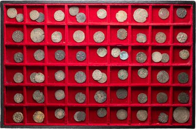 an image of a red display case filled with lots of silver coins