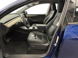 the interior of a blue car with the door open