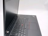 the back of a laptop with a black keyboard on a white surface