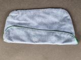 a close up of a small grey bag on a table