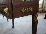 a small desk with a drawer on it in a room