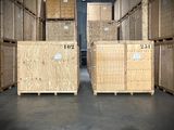 many wooden boxes that are stacked up in a warehouse
