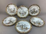 six assiettes en porcelaine ornées d'animaux, posées sur une table