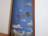 a picture of an airplane painted on a piece of wood