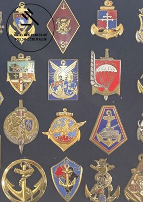 many different military badges displayed on a black surface