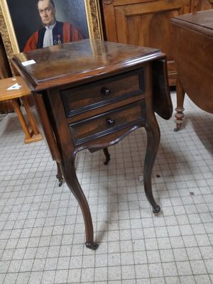 a small table with a picture on it in a room