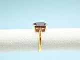 an image of a gold ring with a brown stone on it