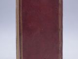 a close up of a book on a white surface with a white background