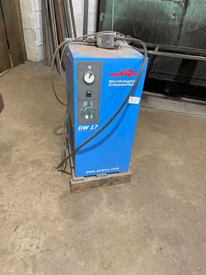 a blue machine that is sitting in a garage