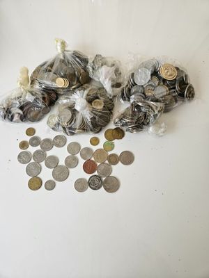 a lot of coins on the table with a bag of them