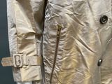an image of a mannequin wearing a beige trench coat