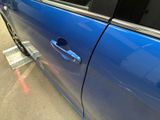 a blue car that is parked in a parking lot