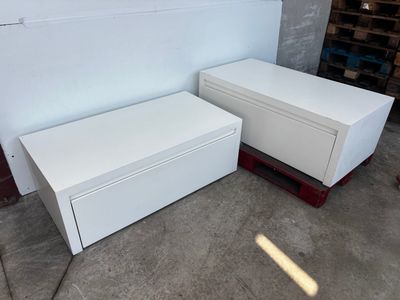 two white chests sitting next to each other on the floor