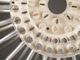 a picture of a close up of a machine with many screws on it